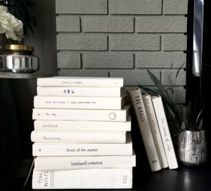 stack of vintage white books painted hardcover hearth fireplace decor bedroom white cream chalk paint greens neutral decor DIY