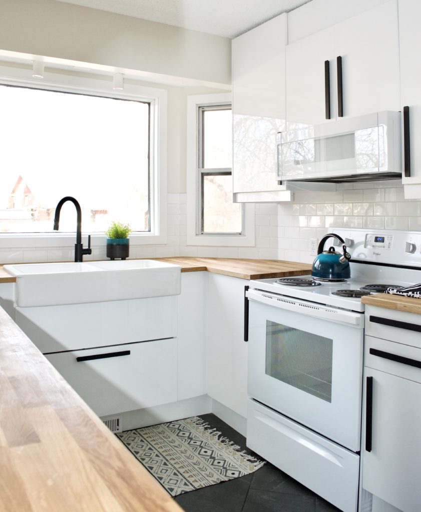 modern farmhouse kitchen white gloss ikea cabinet ringhult with black hackas handles grey tile floor herringbone black faucet green kettle