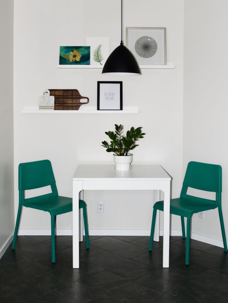 small dining nook breakfast nook kitchen awkward corner green chairs teal white herringbone tile grey gray 12x24" inches 1x2' feet photo ledges black pendant light eat in kitchen styled shelf