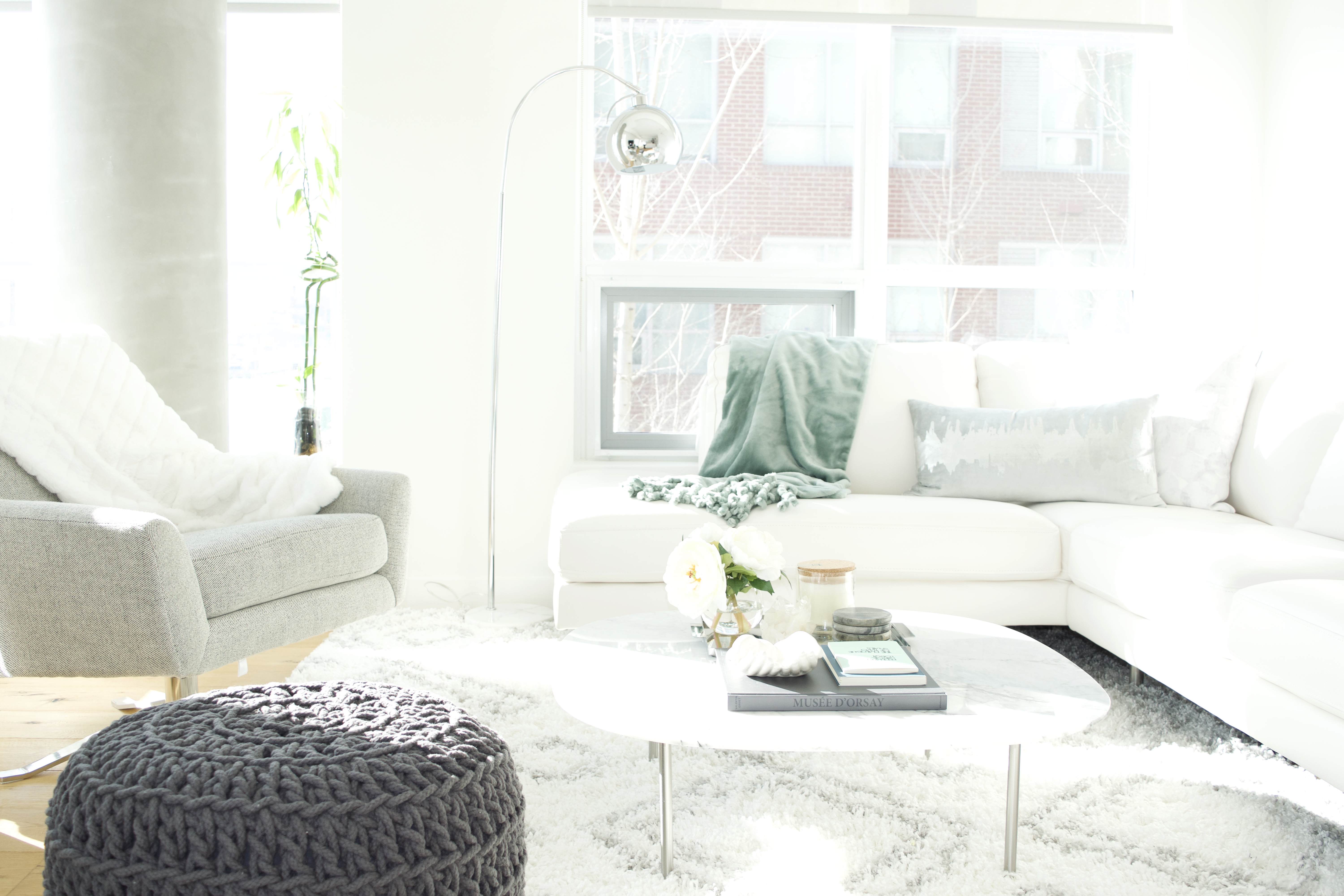 modern scandinavian scandi glam white grey black ivory concrete pillar design swivel chair sectional silver decor living room apartment small space marble table white leather sectional seafoam green pastel soft bright white paint calgary interior designer home by freya maclean pouf ottoman knit