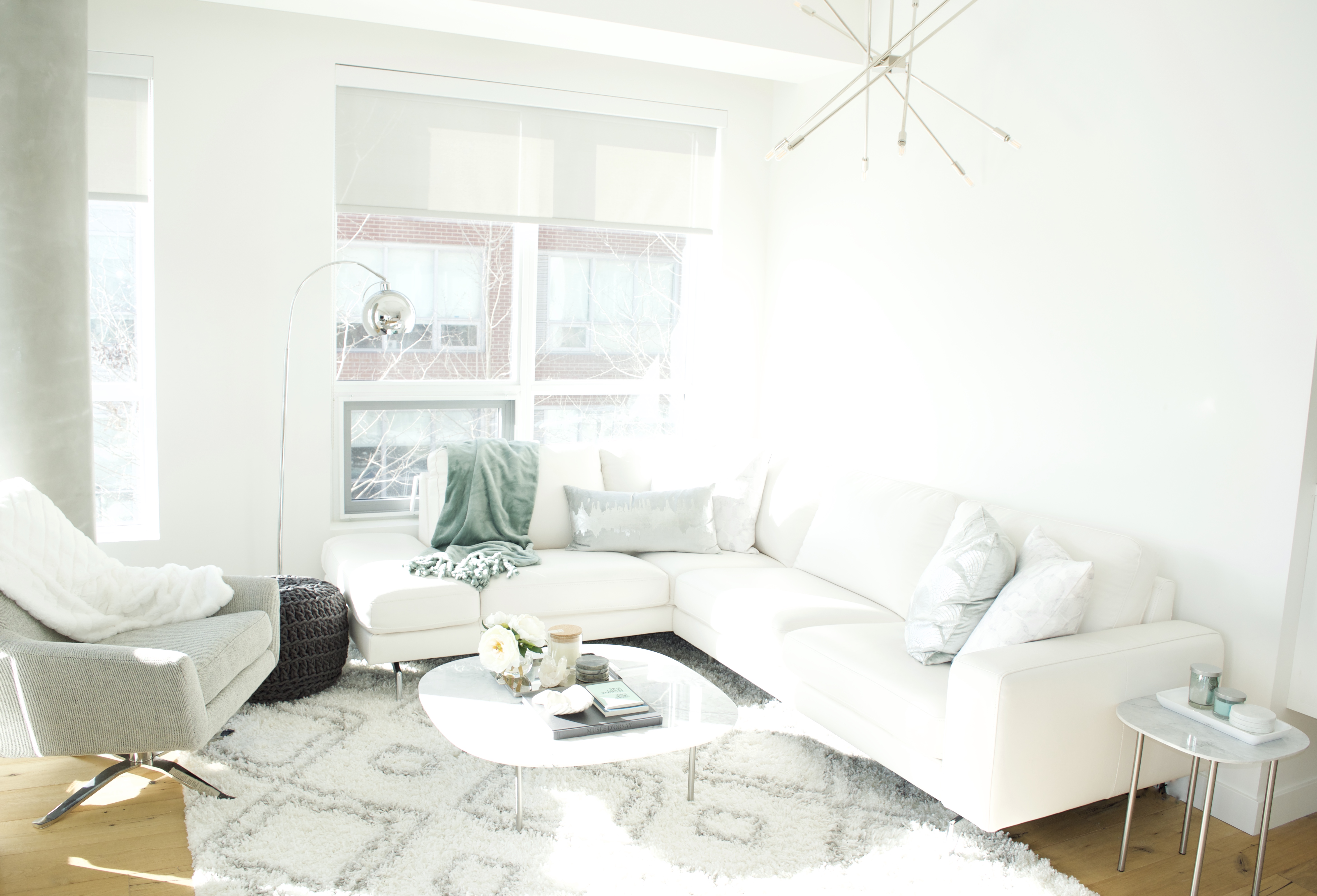 modern scandinavian scandi glam white grey black ivory concrete pillar design swivel chair sectional silver decor living room apartment small space marble table white leather sectional seafoam green pastel soft bright white paint calgary interior designer home by freya maclean pouf ottoman knit arc lamp