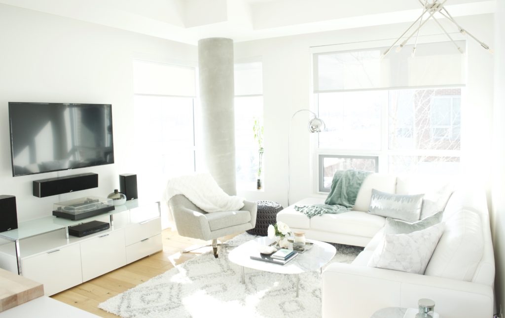 modern scandinavian scandi glam white grey black ivory concrete pillar design swivel chair sectional silver decor living room apartment small space marble table white leather sectional seafoam green pastel soft bright white paint calgary interior designer home by freya maclean