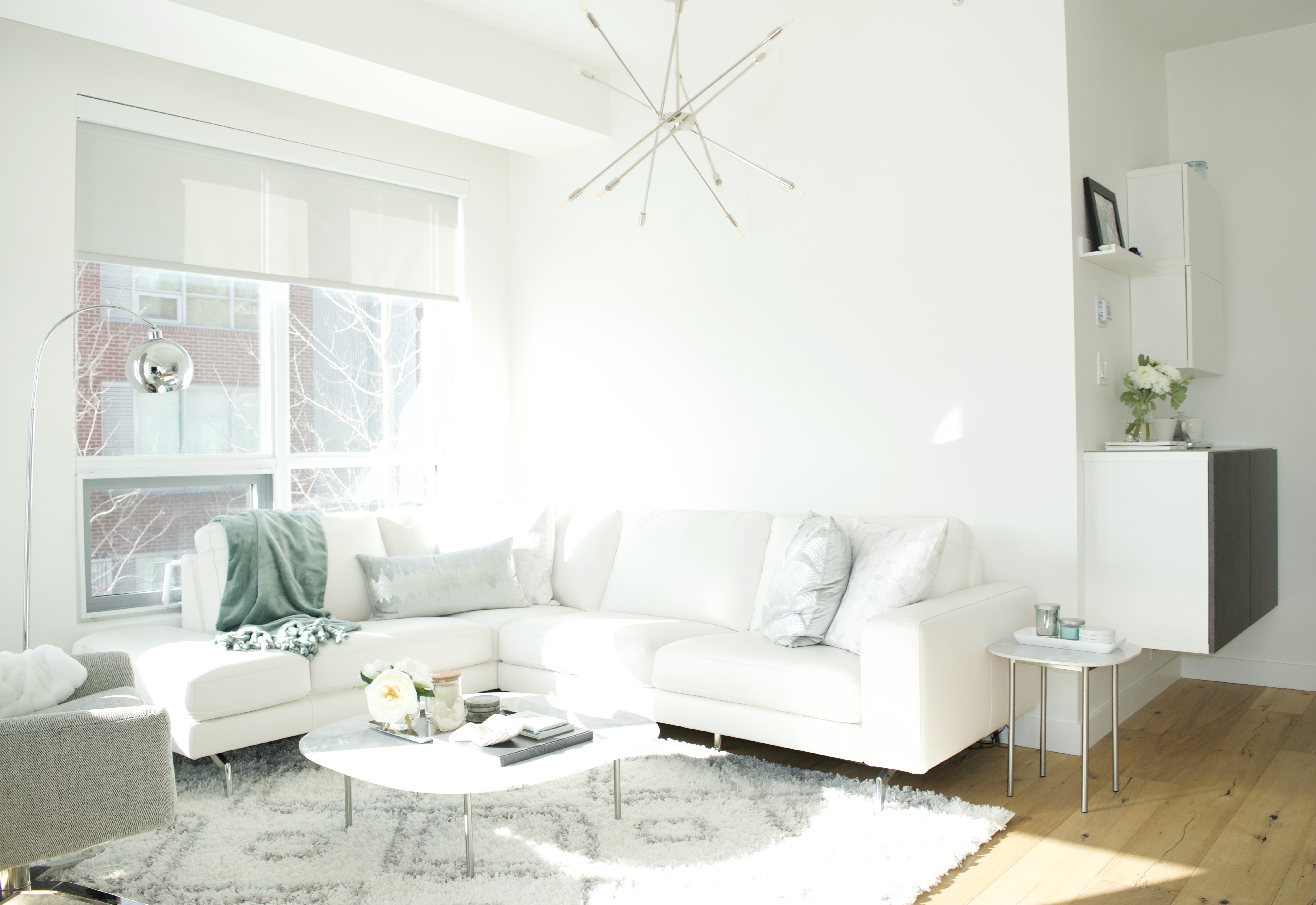 modern scandinavian scandi glam white grey black ivory concrete pillar design swivel chair sectional silver decor living room apartment small space marble table white leather sectional seafoam green pastel soft bright white paint calgary interior designer home by freya maclean