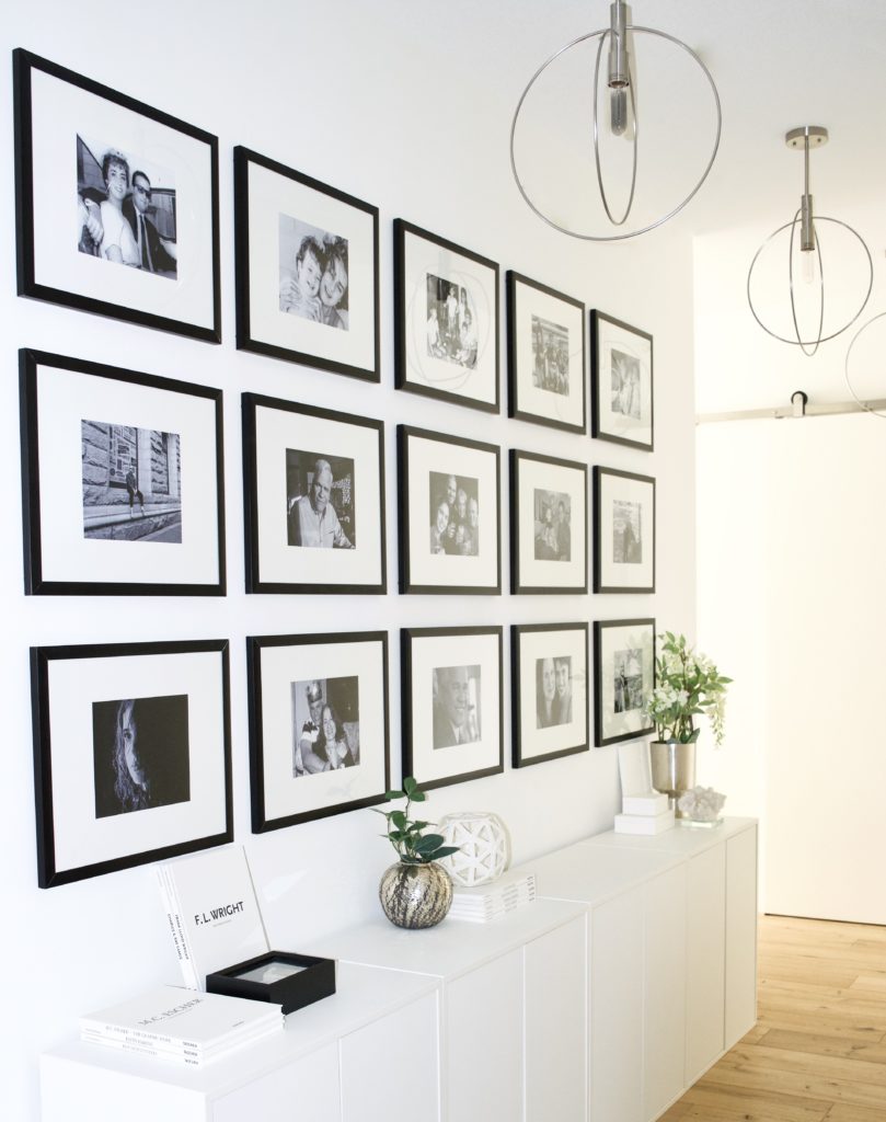 hallway entry gallery wall floor to ceiling white cabinets black frames glam modern scandinavian condo apartment design ideas ikea oak wood floors white walls grid minimal