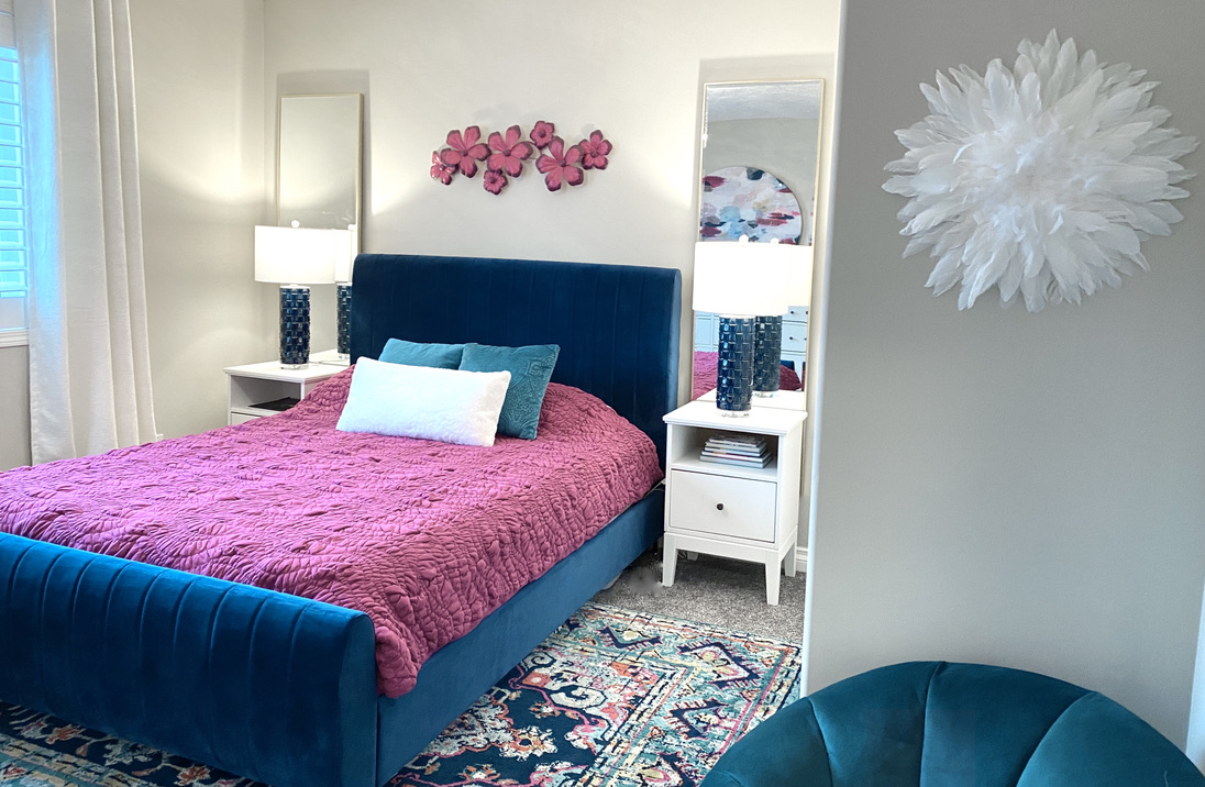 girls room navy fuschia magenta royal blue turquoise teal pink flowers queen bed tween teen grown up girly bright rug bold colourful brass juju feather art floral puff puffy white