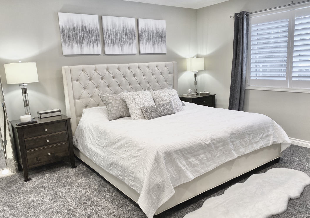 primary bedroom contemporary transitional brown wood furniture dark grey gray velvet curtains fan modern sparkle art beige bed upholstered acrylic chome table lamps bedside white ivory neutral calgary high headboard sheepskin
