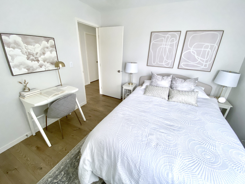 guest bedroom room taupe grey beige tan white ivory desk queen bed small space narrow bedside tables cloud art neutral wall art soft timeless light