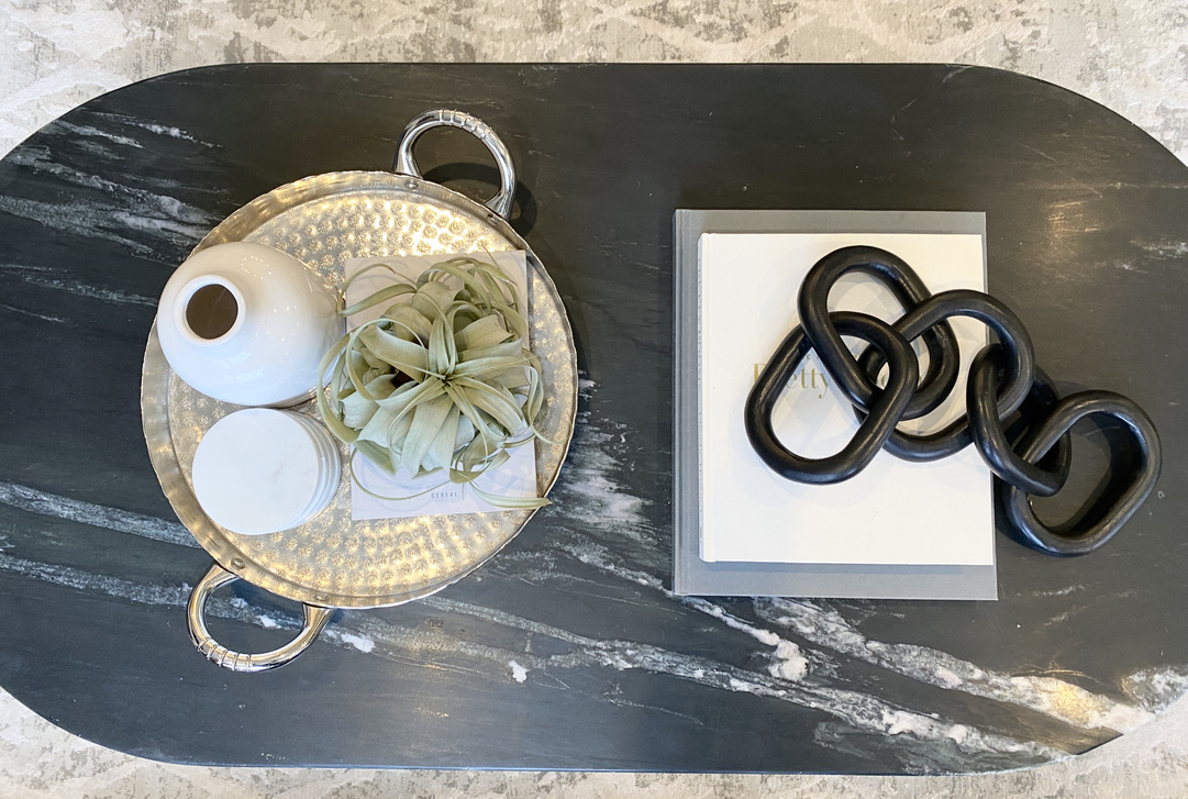 black marble oval coffee table decor styling to to style air plant wood chain large books grey white silver glam minimal modern simple