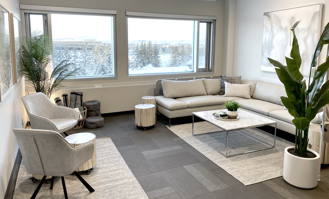 staff wellness room commercial corporate office interior design designer, living room sitting area zones, flex flexible seating, tree stump end coffee tables log stools on caster wheels, neutral, soft monochrome, benjamin moore classic gray window